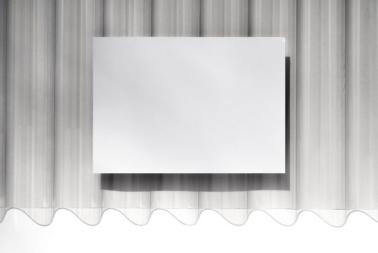 Blank white paper poster mockup with soft shadows on a textured curtain backdrop, ideal for clean and elegant graphic presentations.